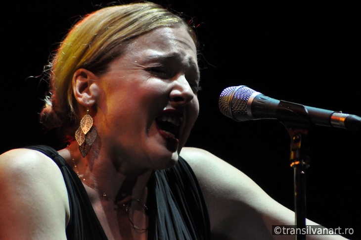 Blonde woman singing in microphone