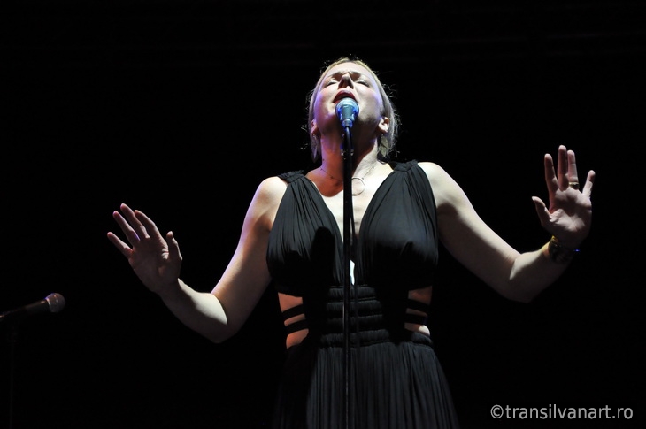 Blonde woman singing on the stage