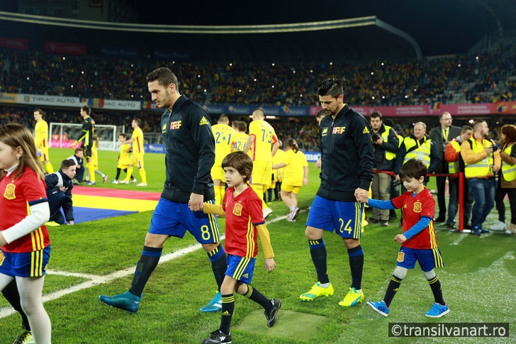 Soccer players of Spain and Romania enter the field