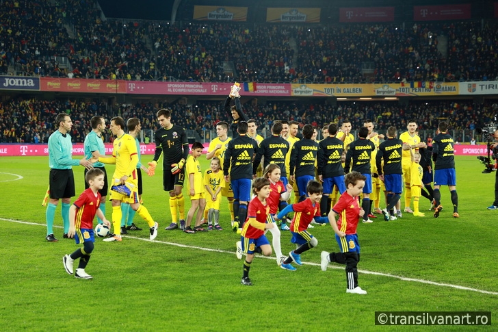 Soccer players of Spain and Romania enter the field