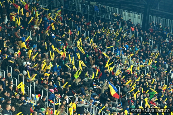 Crowd of people, supporters in a stadium during a football match